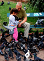 Faces of Argentina: father and daughter feeding birds, Argentina