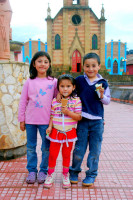 Children eat ice cream during the rain, Raquira, Colombia