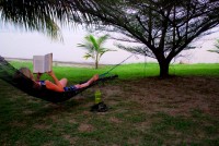 Christi relaxes with a good book at Lake Bosomtwe, Ghana, Africa