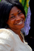 Georgina smiles broadly after selling Christi some Kente cloth. I wonder who got the better of the deal? Kejetia market, Kumasi, Ghana, Africa