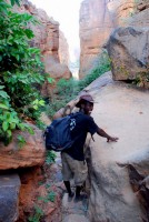 Granpere leads an enthusiastic group of Dragoman travelers down the escarpment to the sandy plains of Dogon Country, Mali, Africa Granpere leads an enthusiastic group of Dragoman travelers down the escarpment to the sandy plains of Dogon Country, Mali, Africa