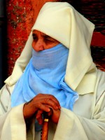 Local Moslem lady watches the world go by, Marrakesh souq, Morocco, Africa