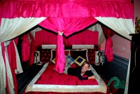 Christi relaxes on our four-poster bed, riad Khouloud, Fes, Morocco, Africa