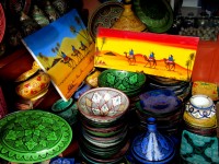 Can I interest you in a tajine pot or a classic Saharan landscape painting? Marrakesh souq, Morocco, Africa