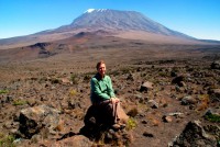 The massive peak of Kilimanjaro looms large and foreboding above Christi, Kilimanjaro National Park, Tanzania, Africa